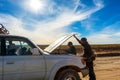 Driver and Tourists fix broken car during 4x4 Jeep Tour on Bolivian Altiplano, Bolivia Royalty Free Stock Photo